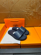 Hermes navy slide sandals with embossed H strap and molded footbed