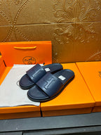 Hermes navy slide sandals with cushioned sole and wide front strap