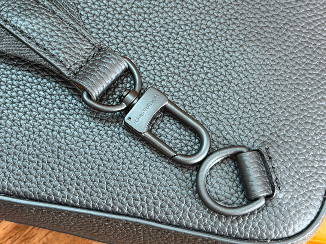 Louis Vuitton men's crossbody bag close-up of D-ring and leather strap attachment