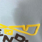 Long-sleeve sweatshirt graphic detail: yellow outline bow with dark letter shapes