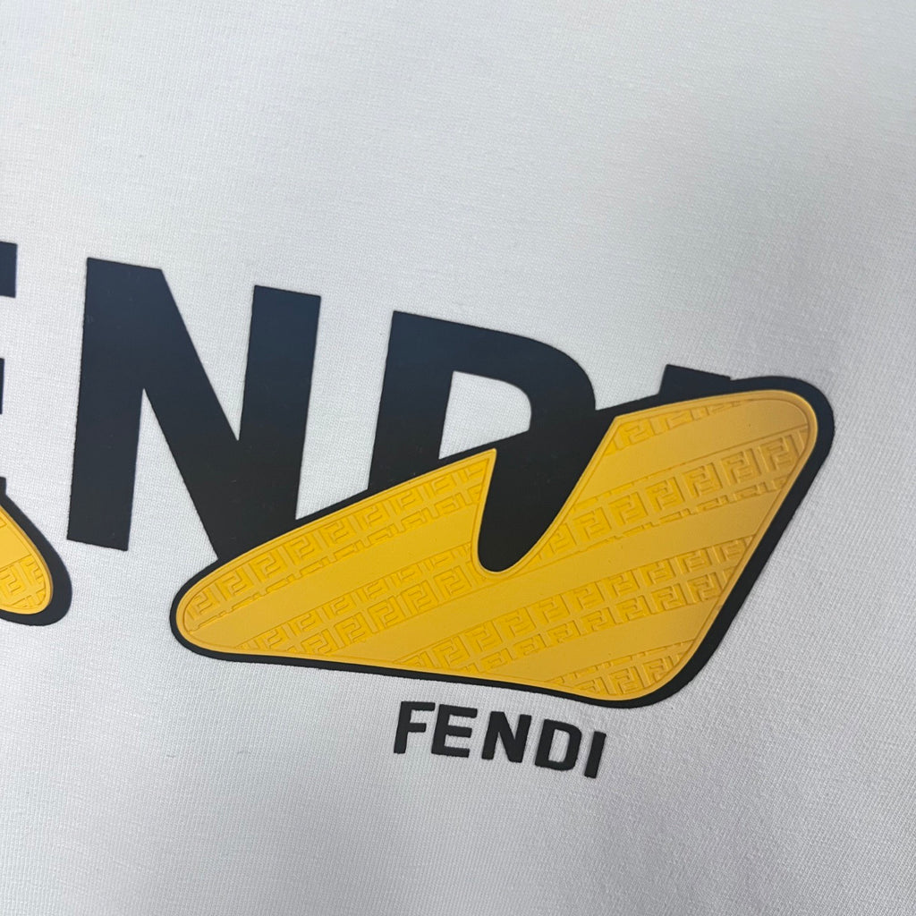 Close-up of FENDI lettering on white sweatshirt with yellow shield logo