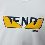 Close-up of white sweatshirt with FENDI text and yellow shield graphic