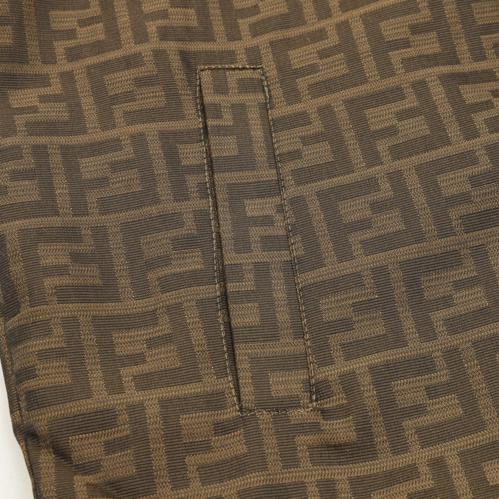 Brown FF hooded jacket front seam detail with stitched piping and vertical placket.