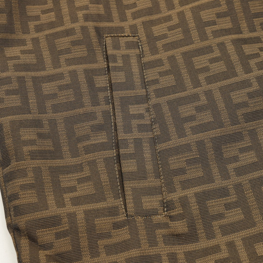 Brown FF hooded jacket front seam detail with stitched piping and vertical placket.