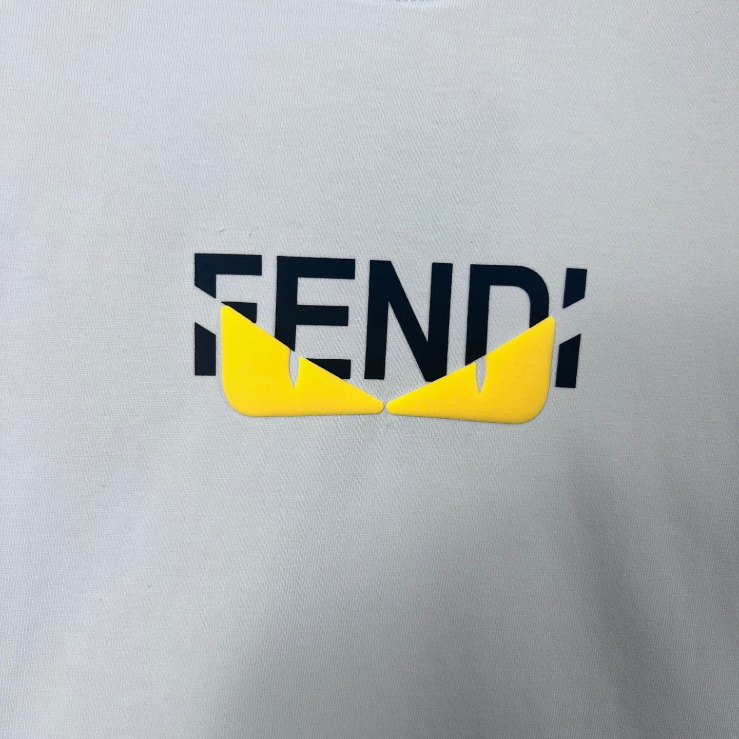 FENDI logo on a white sweatshirt with yellow graphic