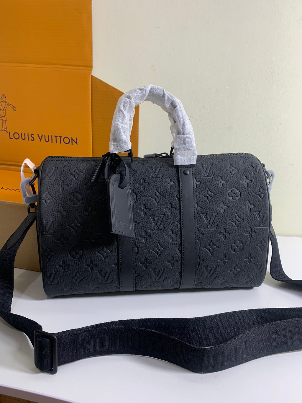 Louis Vuitton monogram duffel bag in dark gray with top handles and shoulder strap