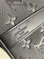 Embossed logo label on monogram duffel bag exterior