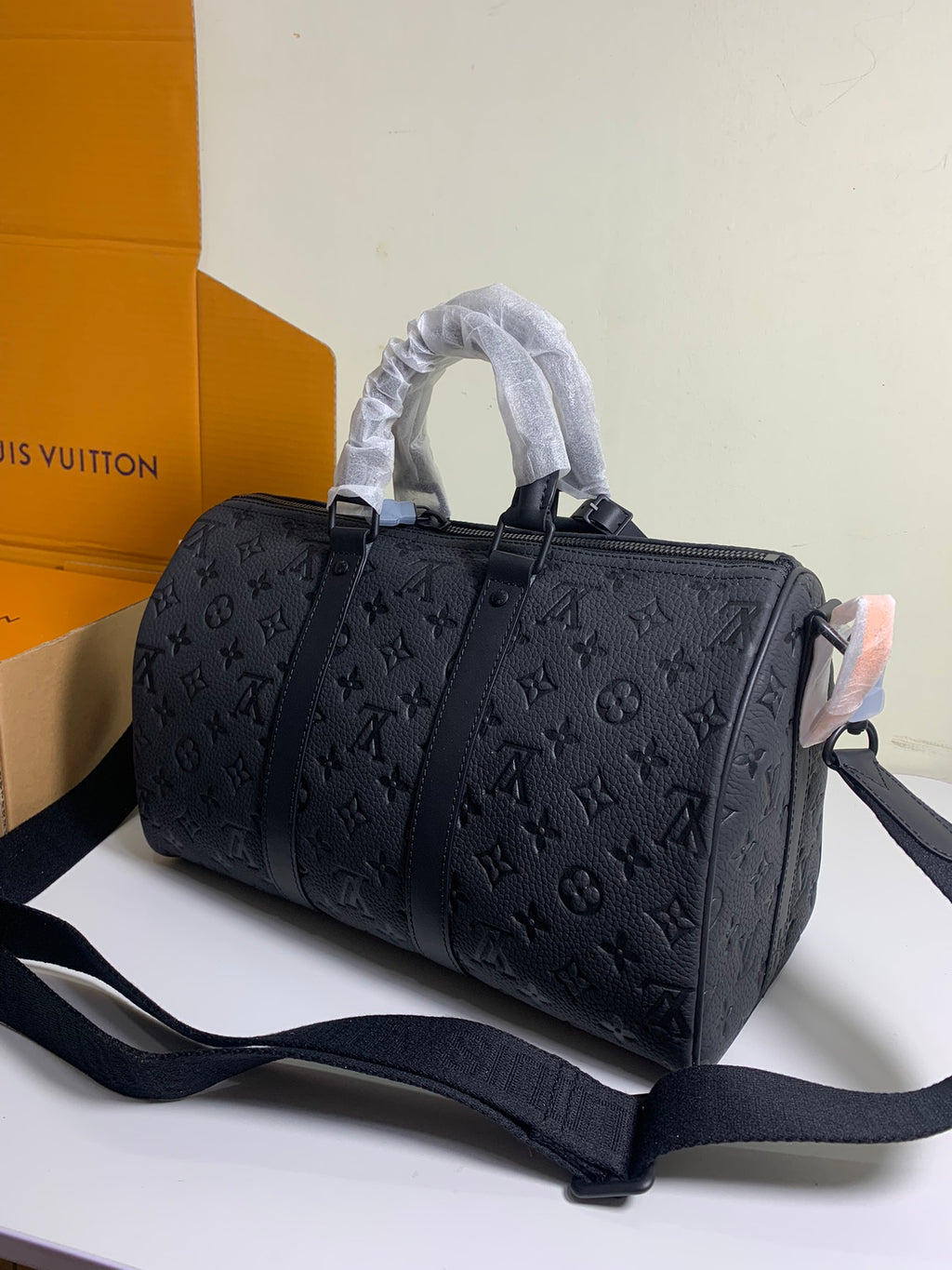 Monogram duffel bag with rolled top handles and wide detachable shoulder strap