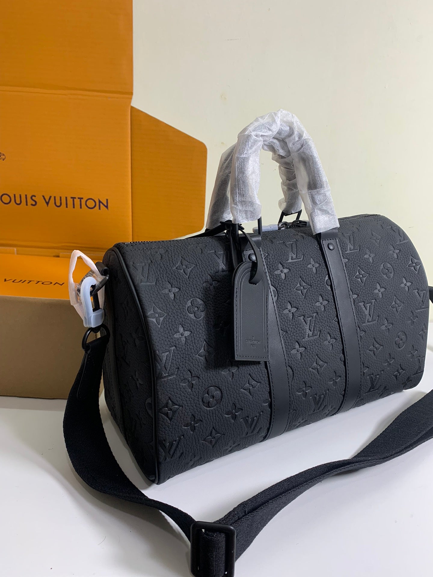 Monogram duffel bag in dark gray with structured body and detachable strap