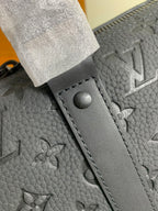 Monogram duffel bag strap end with snap button on textured leather