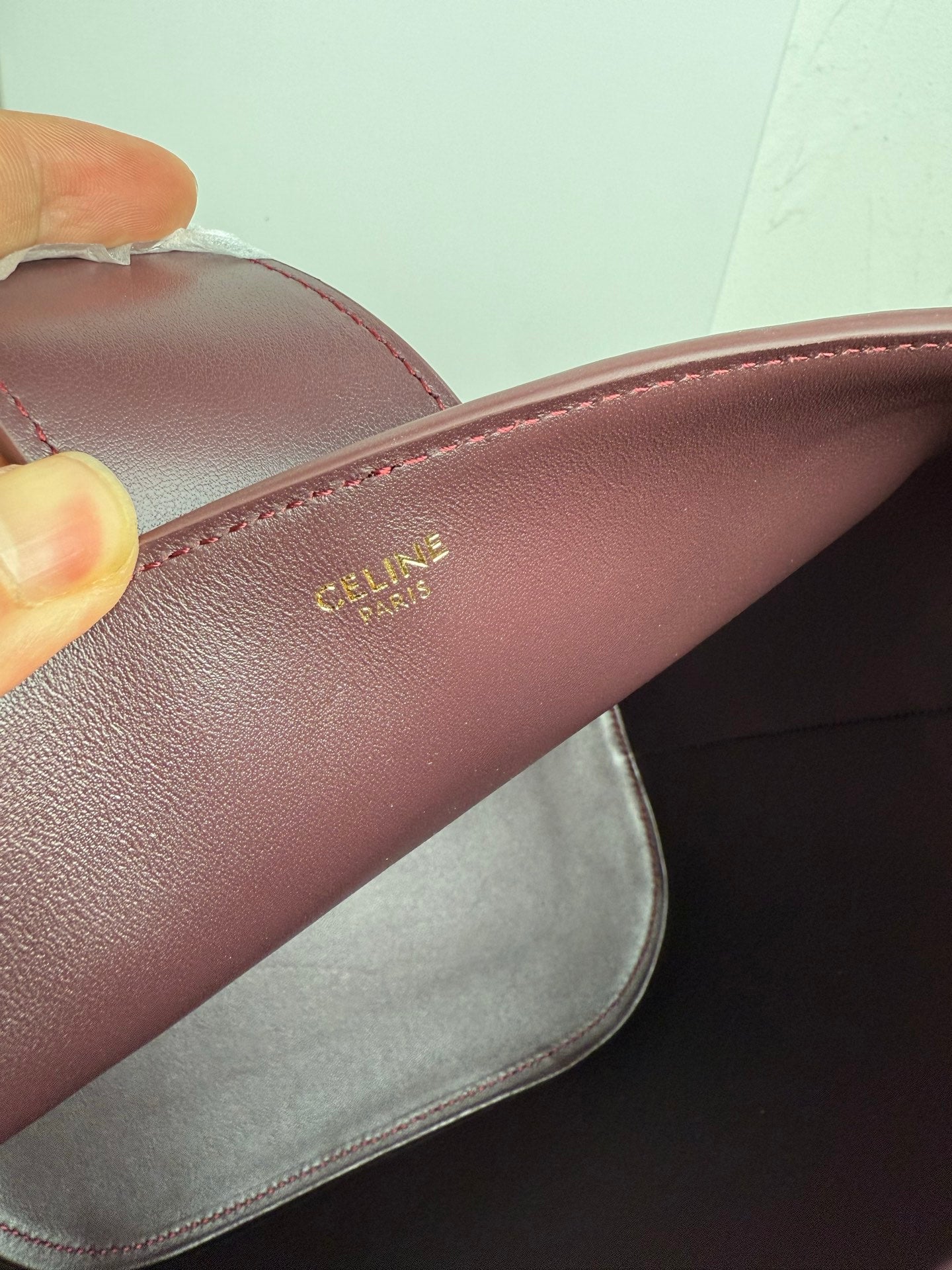 Celine burgundy leather strap with gold Celine Paris logo stamp