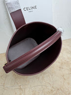 Celine burgundy leather bucket bag interior with gray lining and wide strap