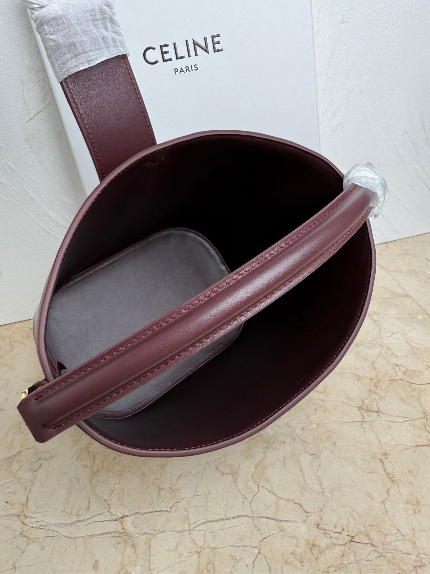 Celine burgundy leather bucket bag interior with gray lining and wide strap