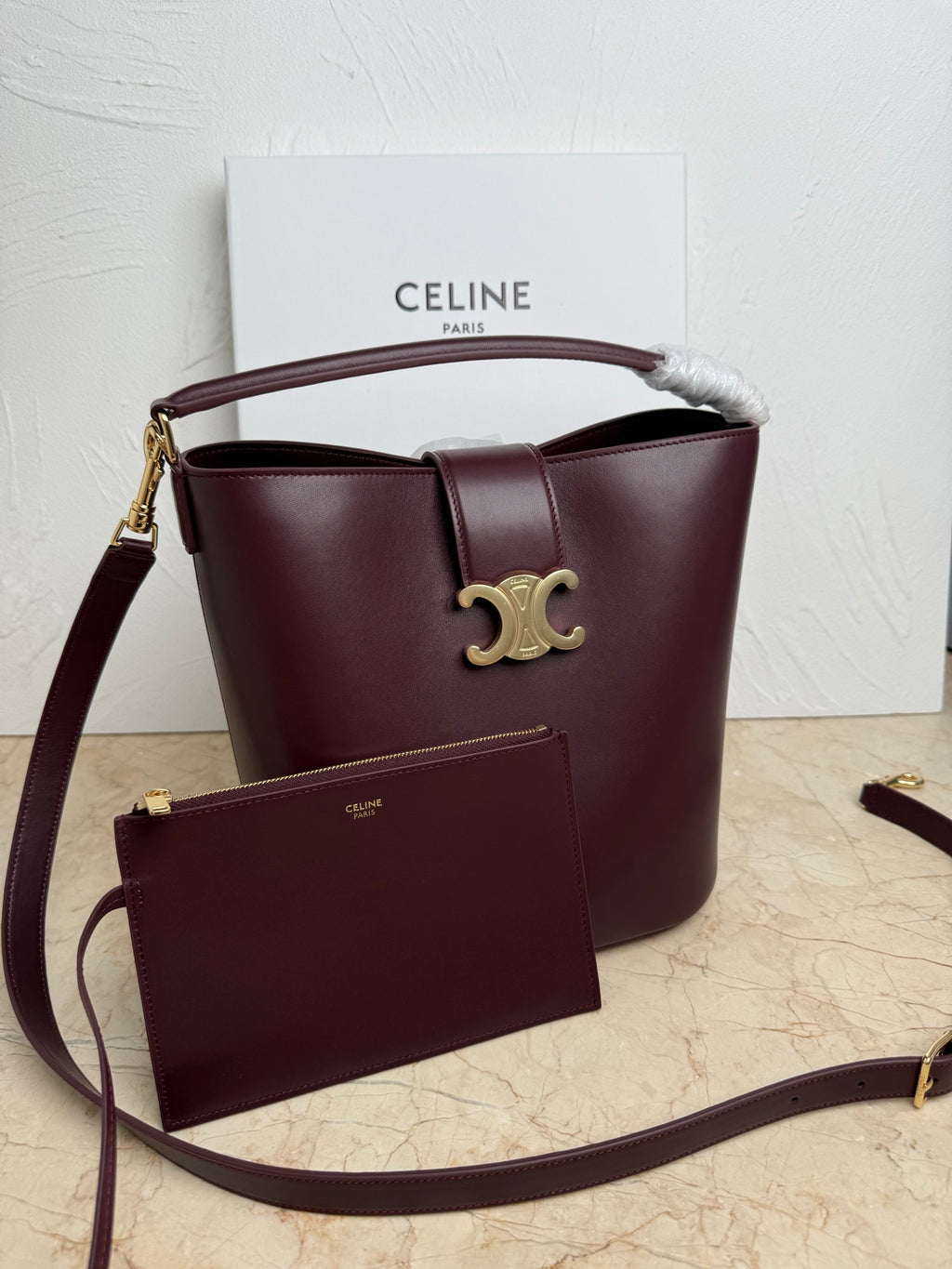 Celine burgundy leather bucket bag with top handle, strap, and front pouch