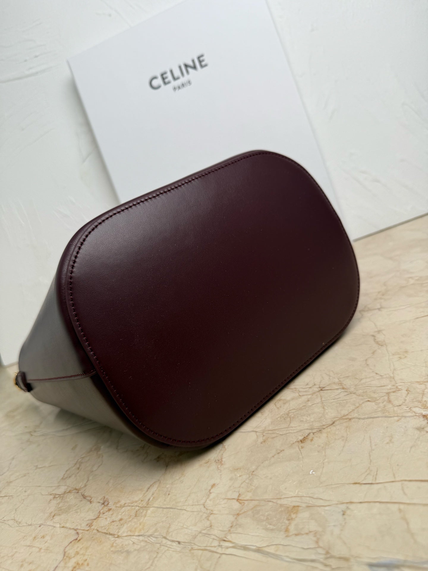 Celine burgundy leather bucket bag with rounded sides and shoulder strap