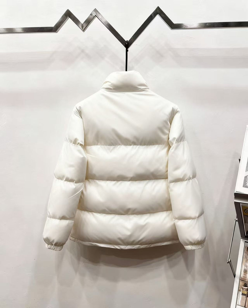 Gucci white puffer jacket, back view with quilted panels and striped waist band
