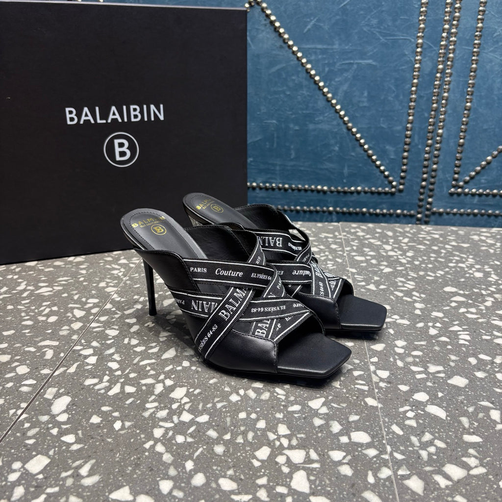 Black slide sandals with logo-print crisscross straps and thin high stiletto heel