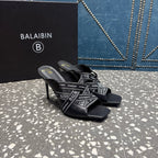 Black slide sandals with logo-print crisscross straps and thin high stiletto heel