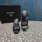 Pair of black open-toe slide sandals with logo-print straps and stiletto heels