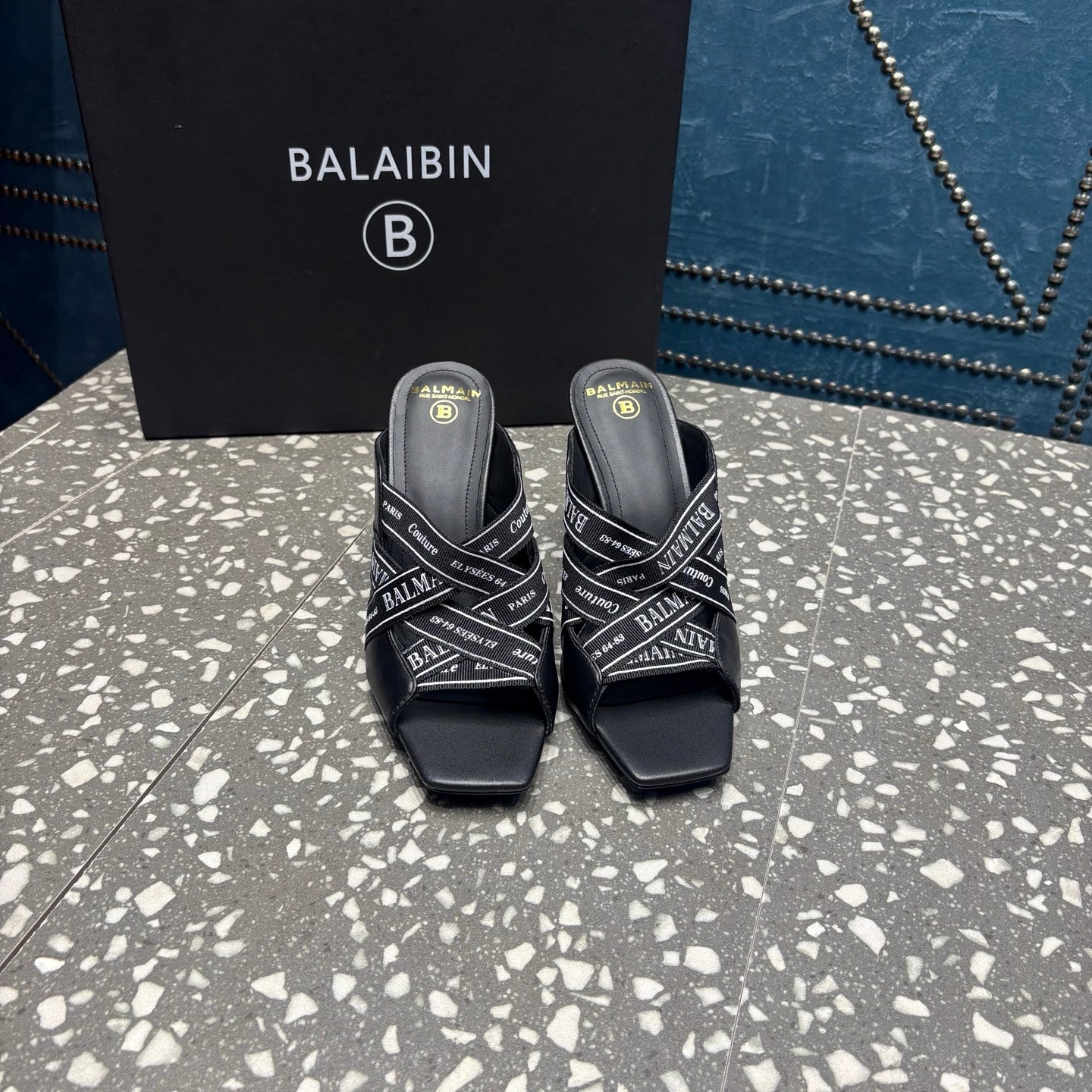 Black slide sandals with open toe and logo-print strap, square platform heel