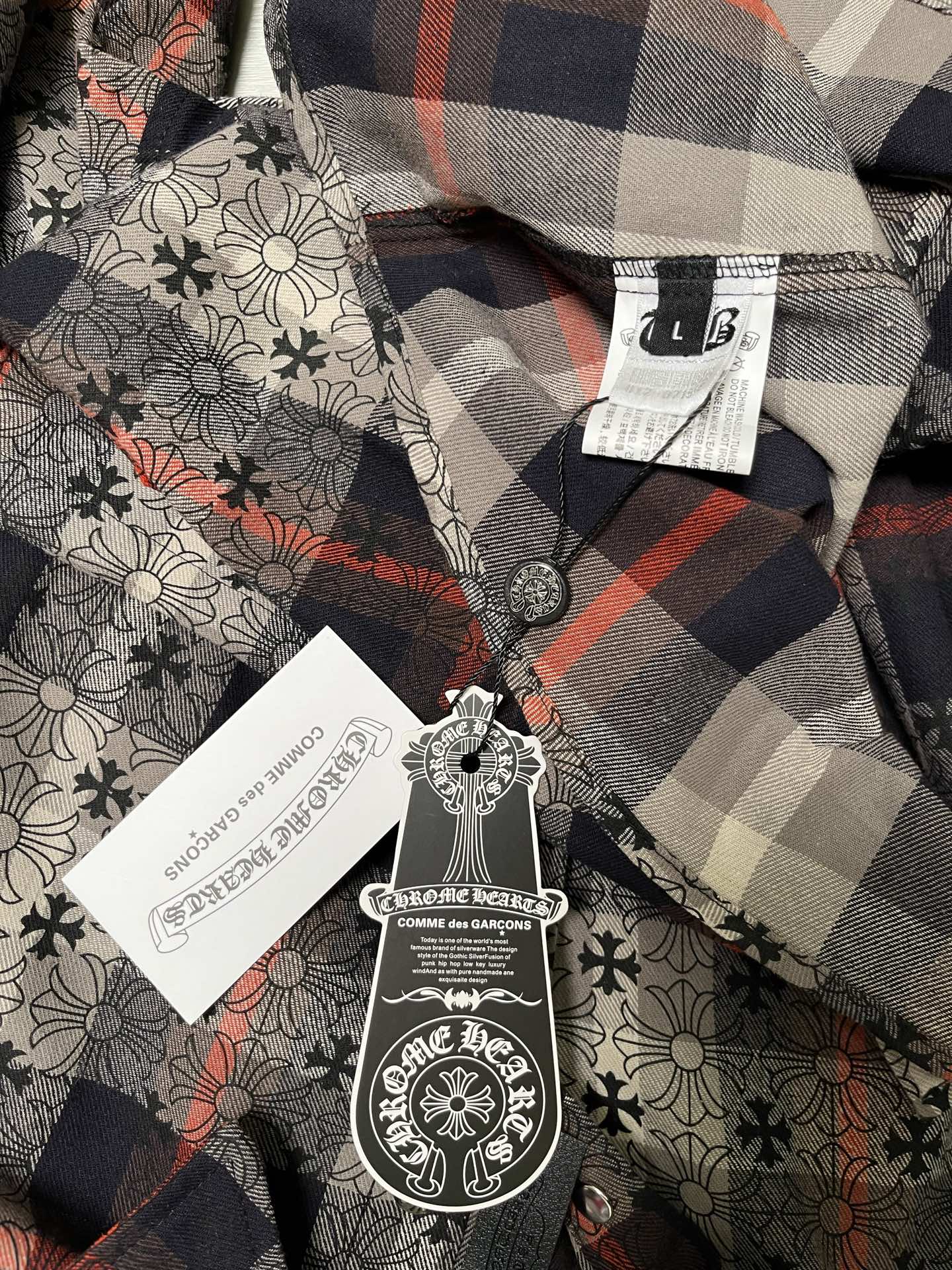 Inside neck label and tags on plaid floral button-up shirt