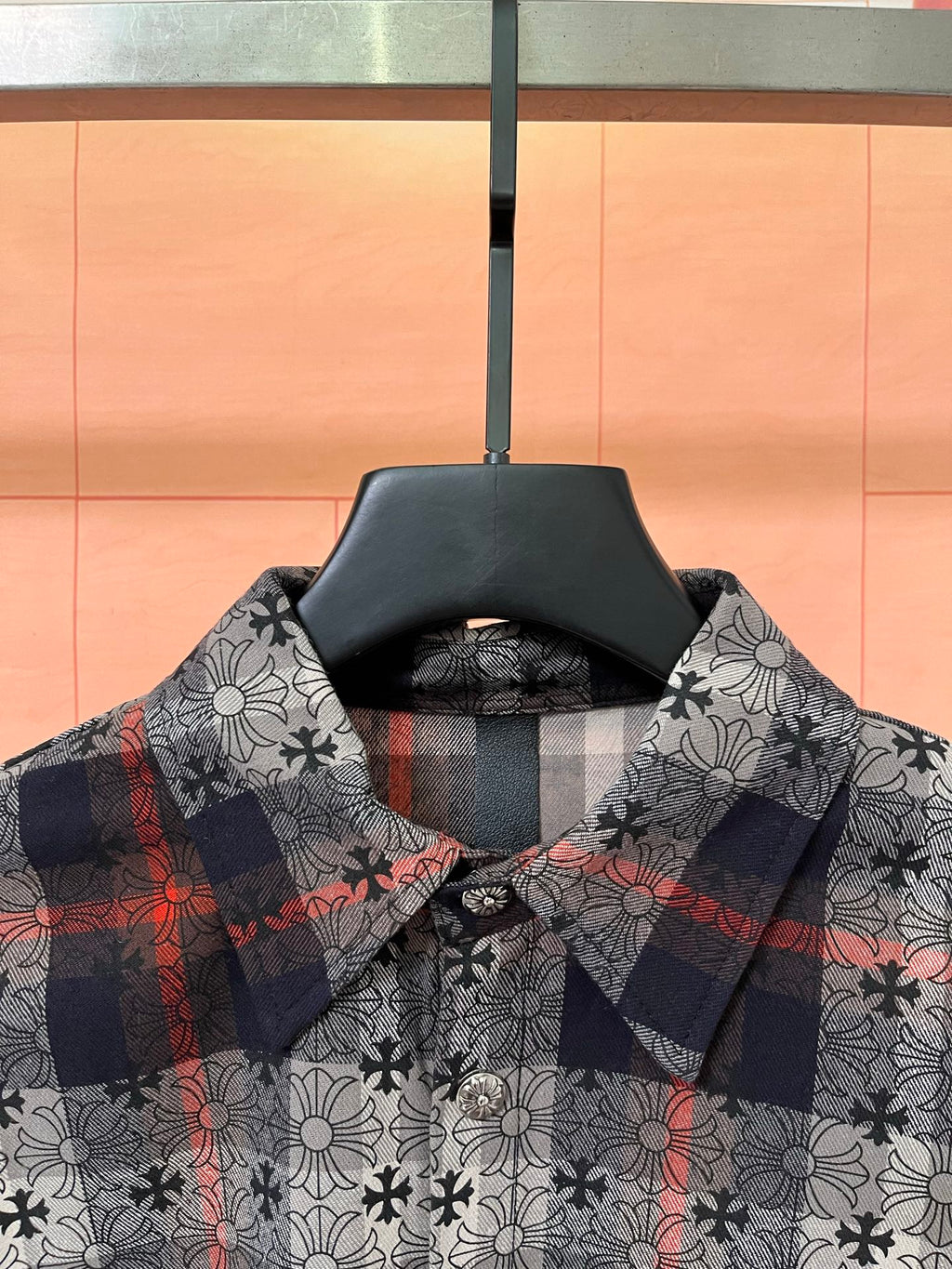 Long-sleeve button-up shirt, dark floral print with red accents and check cuff