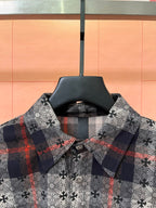 Long-sleeve button-up shirt, dark floral print with red accents and check cuff