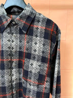 Long-sleeve shirt front with navy plaid squares over white floral print
