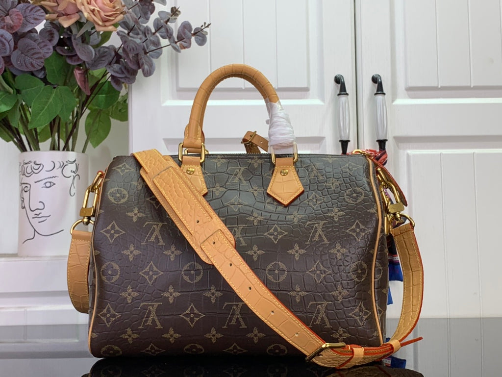 Louis Vuitton monogram duffel bag with top handle, tan strap, and front tags