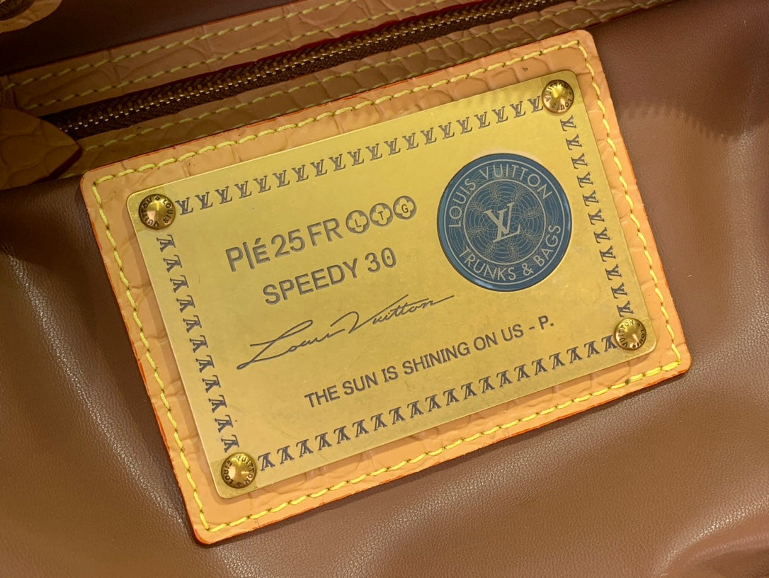 Louis Vuitton leather luggage tag with 'Speedy 30' text and monogram
