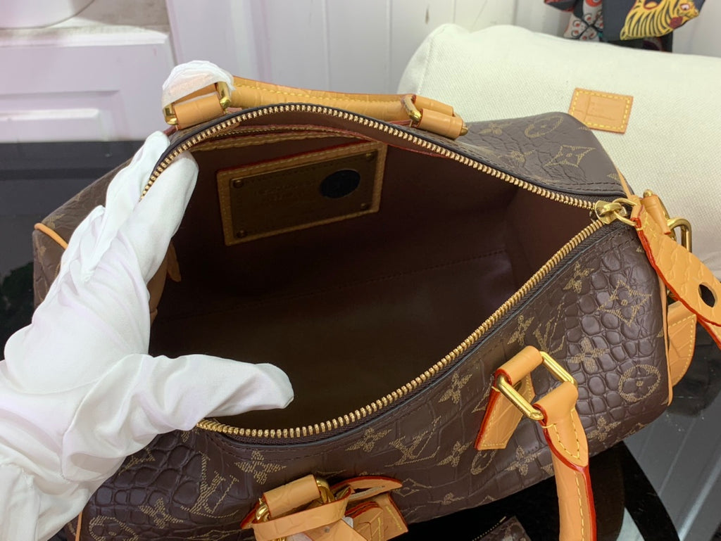 Louis Vuitton duffel bag open interior with zip lining and tan leather pull