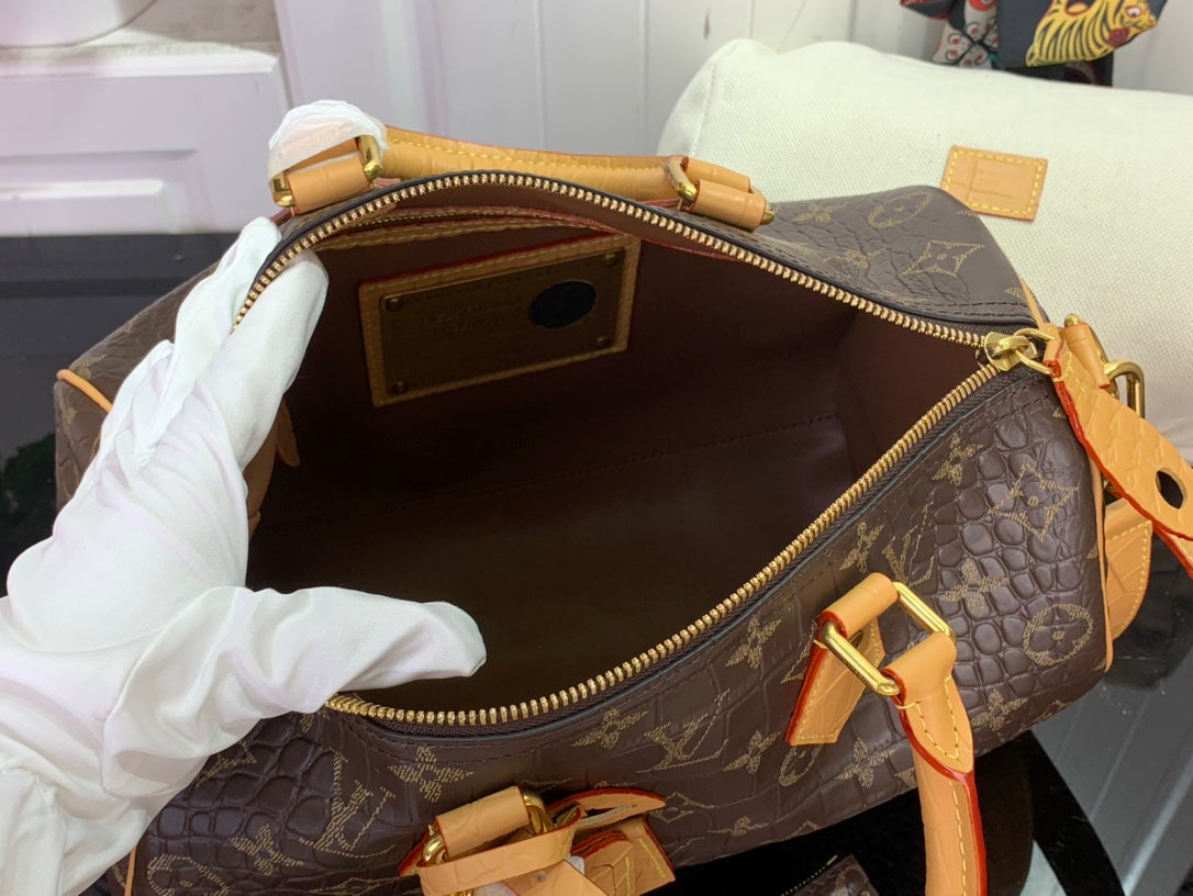 Louis Vuitton duffel bag open interior with zip lining and tan leather pull