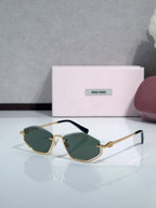 Miu Miu sunglasses with green-tinted lenses, gold-tone frames, and dark teal temples