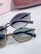 Miu Miu sunglasses showing lens and temple details with dark blue frames and gold accents