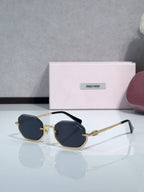 Gold metal hexagonal sunglasses with dark blue lenses and slim blue temples