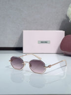 Gold metal hexagonal sunglasses with light brown lenses and cream temple tips