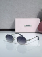 Gold metal hexagonal sunglasses with dark navy lenses and dark blue temple details