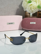 MiuMiu sunglasses with dark blue lenses, gold frame and black details