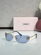 MiuMiu sunglasses with dark blue lenses, blue temples, gold-tone accents