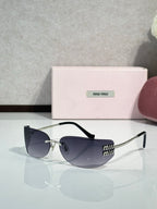 MiuMiu sunglasses with dark blue lenses, black front, gold-tone temples