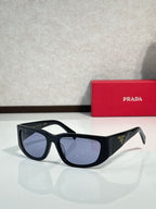 Prada glasses with black cat-eye frames and dark tinted lenses