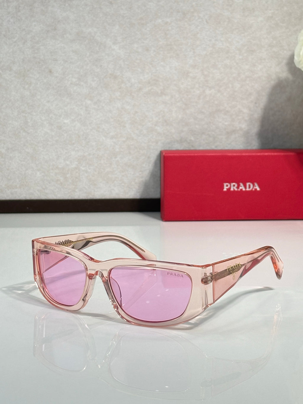 Prada glasses with rose gold frames and pink tinted lenses