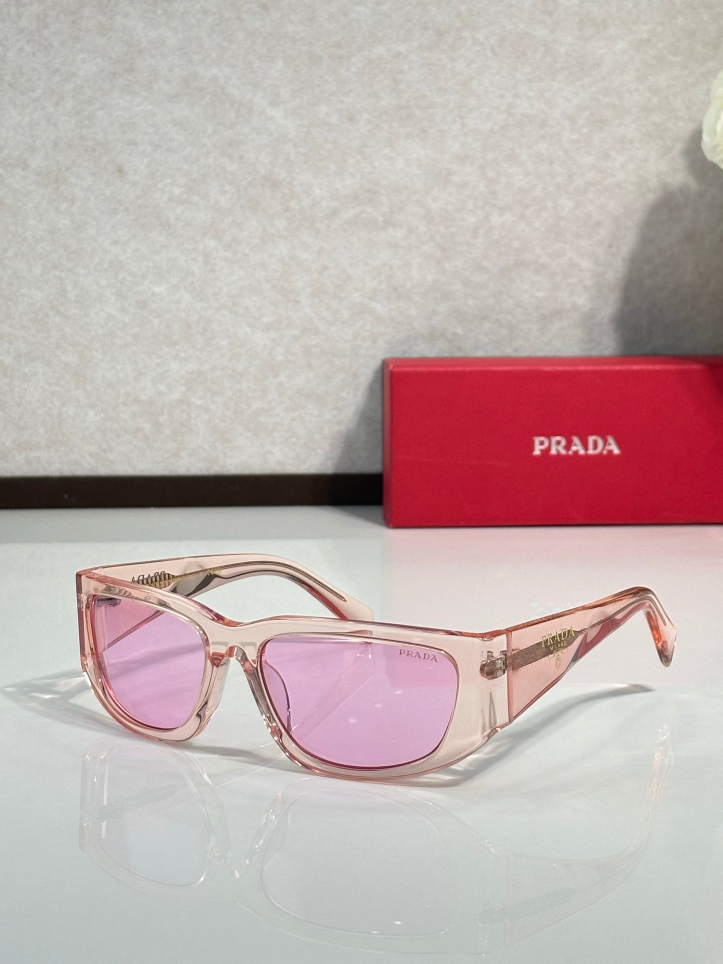Prada glasses with rose gold frames and pink tinted lenses