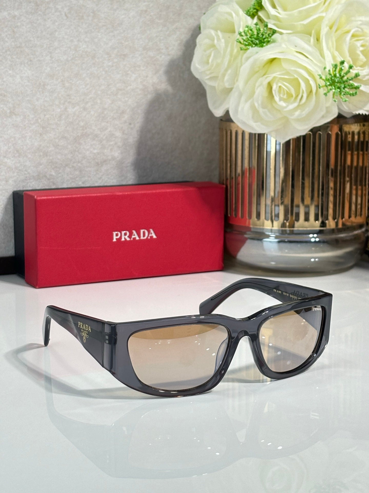 Prada glasses with black thick frames and tinted lenses