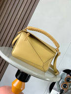 Loewe light yellow leather shoulder bag with braided top handle and gold hardware