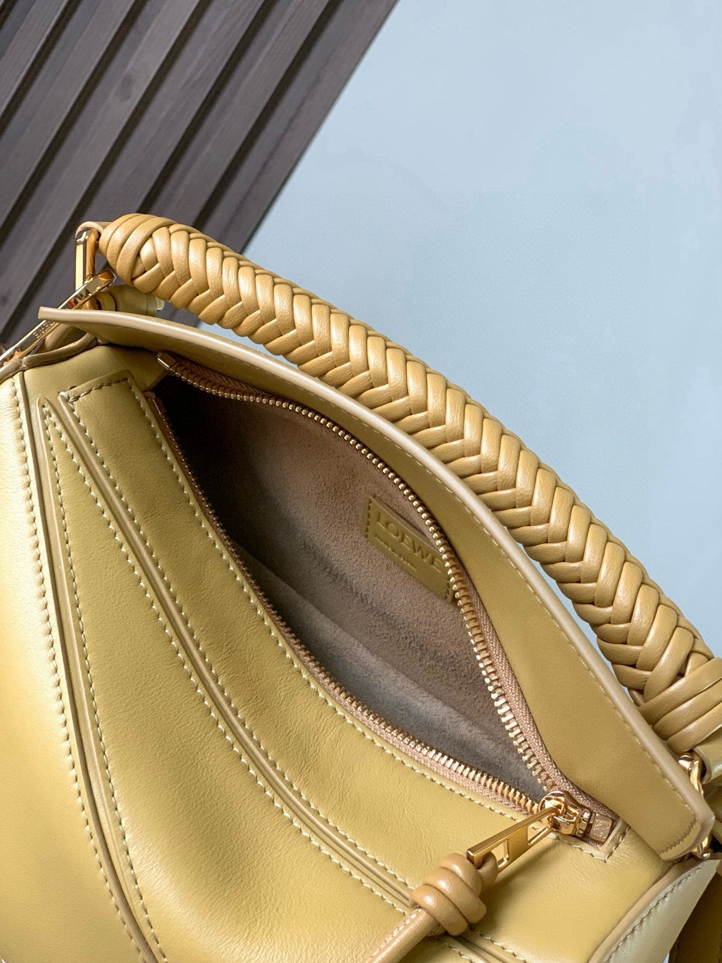 Loewe light yellow leather mini bag interior view with open top and zip pocket