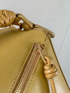 Loewe light yellow leather bag close-up of zip pull and braided side loop detail