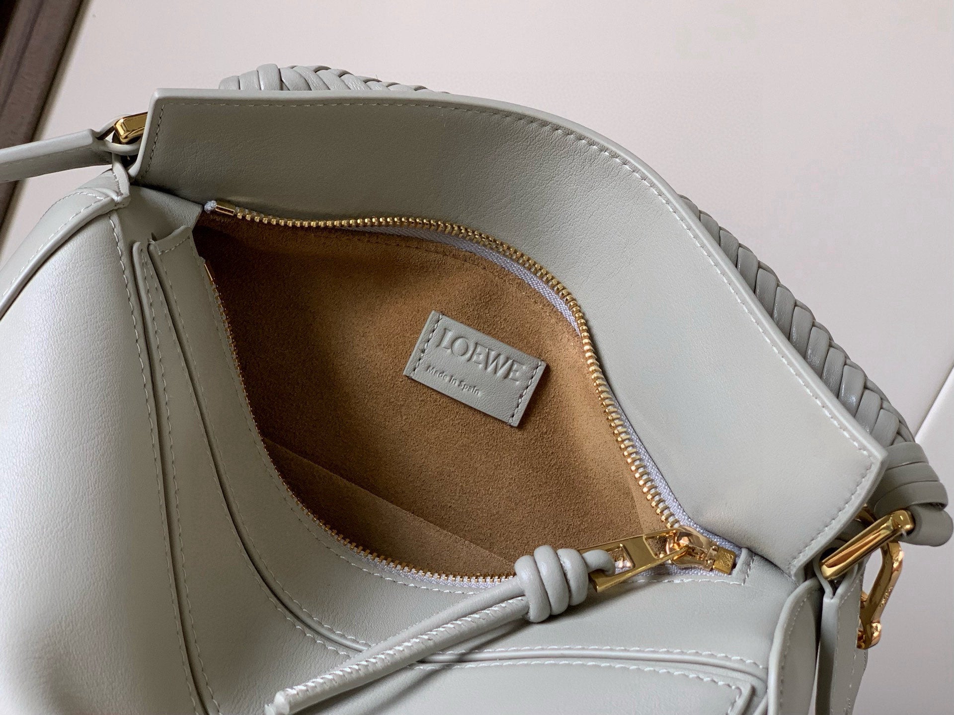 Loewe light blue mini shoulder bag open to tan lining with front brand tag.