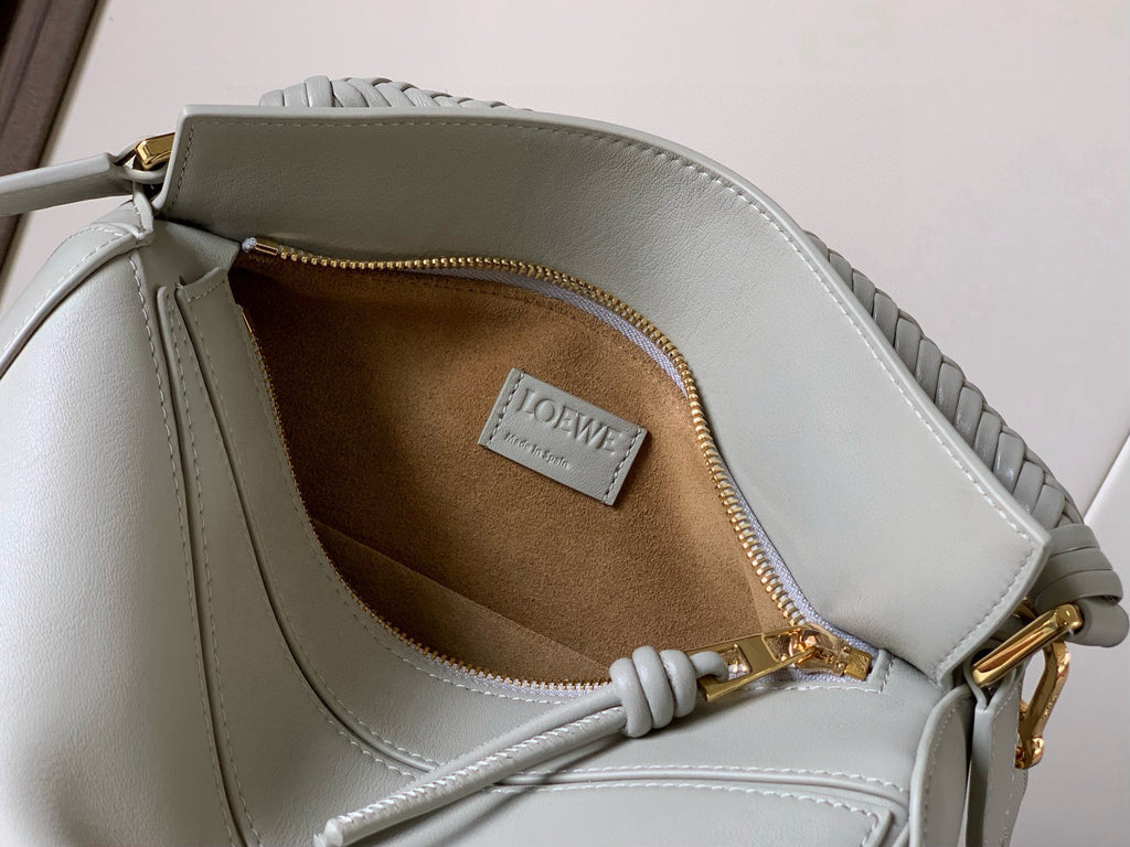Light blue leather crossbody bag with tan interior lining and zip pocket view