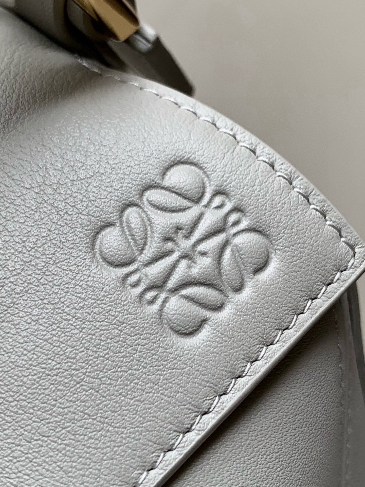 Loewe light blue leather bag with embossed logo on the front panel.
